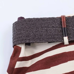 Detail shot of the woven belt and brown geometric print fabric on summer dress