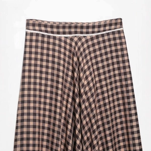 Women's plaid A-line midi skirt in brown and black with delicate white lace trim waistband
