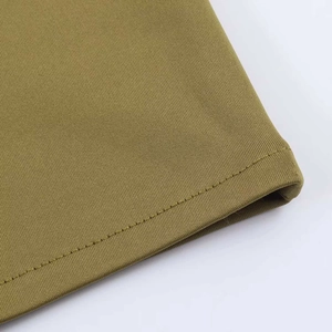 Detailed macro view of mustard yellow knit fabric texture and high-quality hem stitching