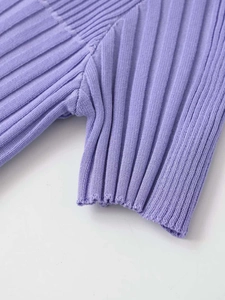 Detail view of light purple ribbed knit fabric with professional stitching and texture