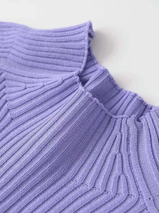 Detailed close-up showing the ribbed texture and fine neckline of the purple knitted top