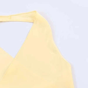 Detail of light yellow satin halter neck top showing clean stitching and fabric texture