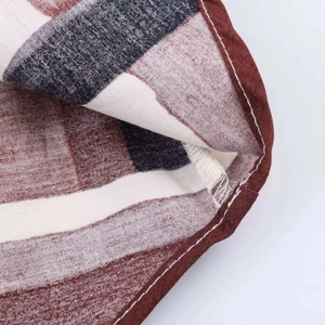 Detailed macro shot of vintage geometric print fabric with neat stitching and cotton texture