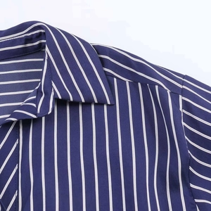 Detailed close-up of navy blue and white striped shirt collar with precision stitching