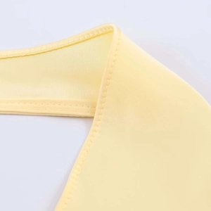 Detail shot of the pale yellow satin halter top neck showing high quality fine stitching
