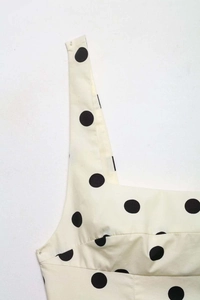 Close-up of polka dot tank top with square neck design and gathered pleat details