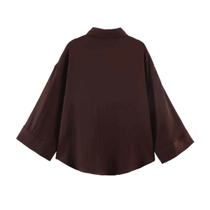 Back view of loose fit dark brown drop shoulder shirt with lightweight fabric texture