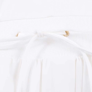 Detail of white V-neck dress elastic waist with golden eyelets and drawstring tie