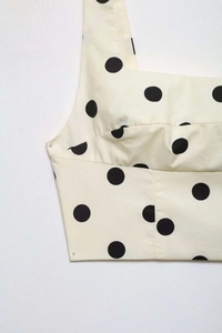 Detailed view of polka dot crop top fabric texture and clean stitching finish
