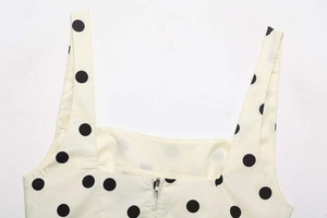 Close-up detail of square neckline and back zipper on polka dot camisole top