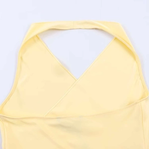 Detail of the cross-neck design and precise stitching on the yellow satin halter top