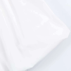 Close-up of white poplin fabric texture and clean stitching on a summer shirt dress
