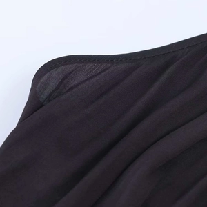 Detail view of high-quality stitching on lightweight black satin fabric with sheer texture
