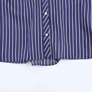 Detail of dark blue striped shirt fabric with white buttons and fine vertical patterns