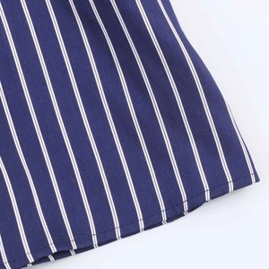 Detailed close-up showing the hem stitching and striped fabric texture of a navy shirt