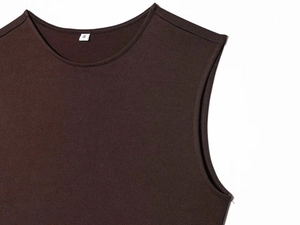 Detail of round neckline and size S tag on textured dark brown knit sleeveless top