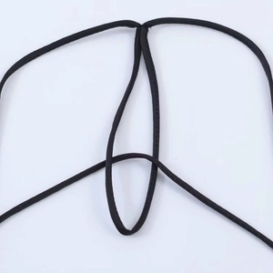 Detail of thin crisscross black straps and stitching on a satin backless dress
