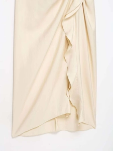 Detailed view of apricot wrap skirt featuring silk texture and ruffle asymmetrical hem
