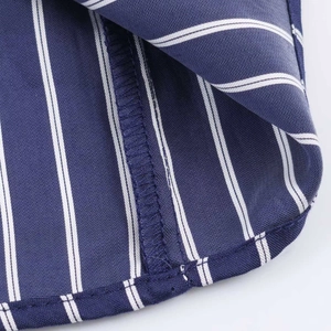 Detailed close-up showing the hem stitching and vertical stripes of the puff sleeve shirt