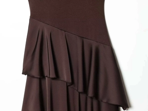 Detailed view of dark brown dress featuring matte texture and glossy satin ruffles