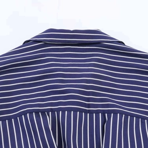 Detail of blue and white striped shirt showing the back yoke stitching and fabric texture