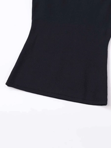 Close-up of smooth hemline and fine knit texture on a black sleeveless knit top