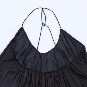 Detail of black satin halter neckline with pleated texture and delicate spaghetti straps