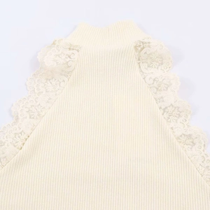 Detail showing lace embroidery on ribbed knit vest collar in elegant beige cream