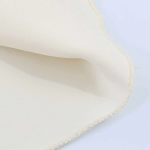 Detailed macro view of ivory silk texture fabric with high-quality stitched edges