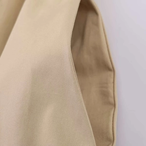 Gros plan du tissu sergé kaki montrant les coutures détaillées et la texture textile