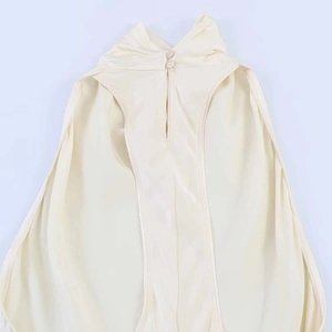 Detail of silk-textured halter neck dress featuring back button closure and cutout