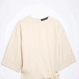 Chic apricot knotted ruffle dress with short sleeves and breathable fabric texture