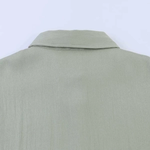 Close-up of light green lapel shirt showing high-quality twill fabric and neat stitching
