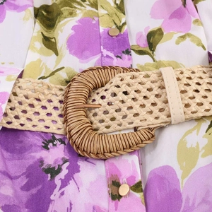 Summer floral print dress featuring a colorful flower pattern and woven straw belt