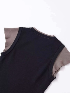 Detail of the crew neck and contrast color stitching on the knit vest sweater