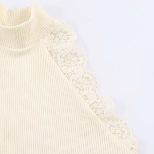 Detail of cream rib-knit top featuring delicate floral lace trim on the shoulder