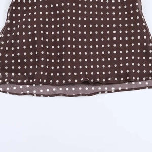 Detailed macro view of chocolate brown chiffon fabric with white polka dots for the top