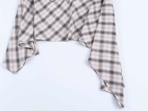 Detail of classic plaid pattern and asymmetric hemline on a minimalist checkered skirt