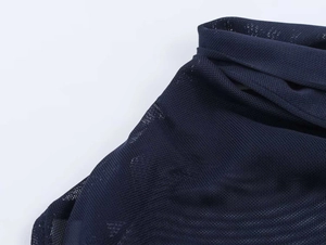 Detail of dark blue mesh fabric showing breathable texture and micro-hole structure