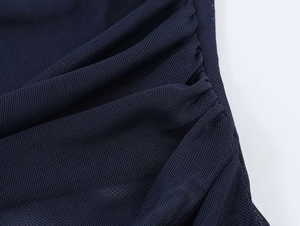 Close-up of ruched texture and dark blue mesh fabric on this slim-fit vest top