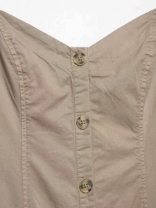 Detailed close-up of khaki midi dress featuring V-neckline and marble texture buttons