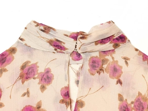 Macro detail of high collar floral chiffon blouse with button closure at the back
