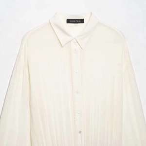 Elegant white long sleeve shirt with vertical pleats and textured fabric detail