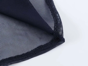 Detail of black mesh fabric showing high-quality overlock stitching and breathable texture