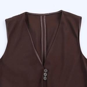 Close-up of deep brown V-neck vest featuring three grey buttons and fine twill fabric texture