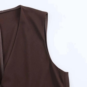 Detail view of a vintage dark brown V-neck vest featuring high-quality edge binding work