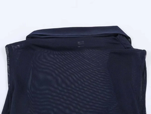 Close-up of navy blue mesh fabric showing texture and solid collar detail on slim vest