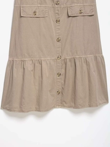 Detail of khaki button-down midi skirt with utility pockets and ruffled hemline