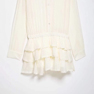 Chic cream long-sleeve ruffled romper with tiered lace edges and pleated chiffon texture