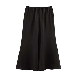 Detail of elegant black satin midi skirt featuring elastic high waist and smooth texture